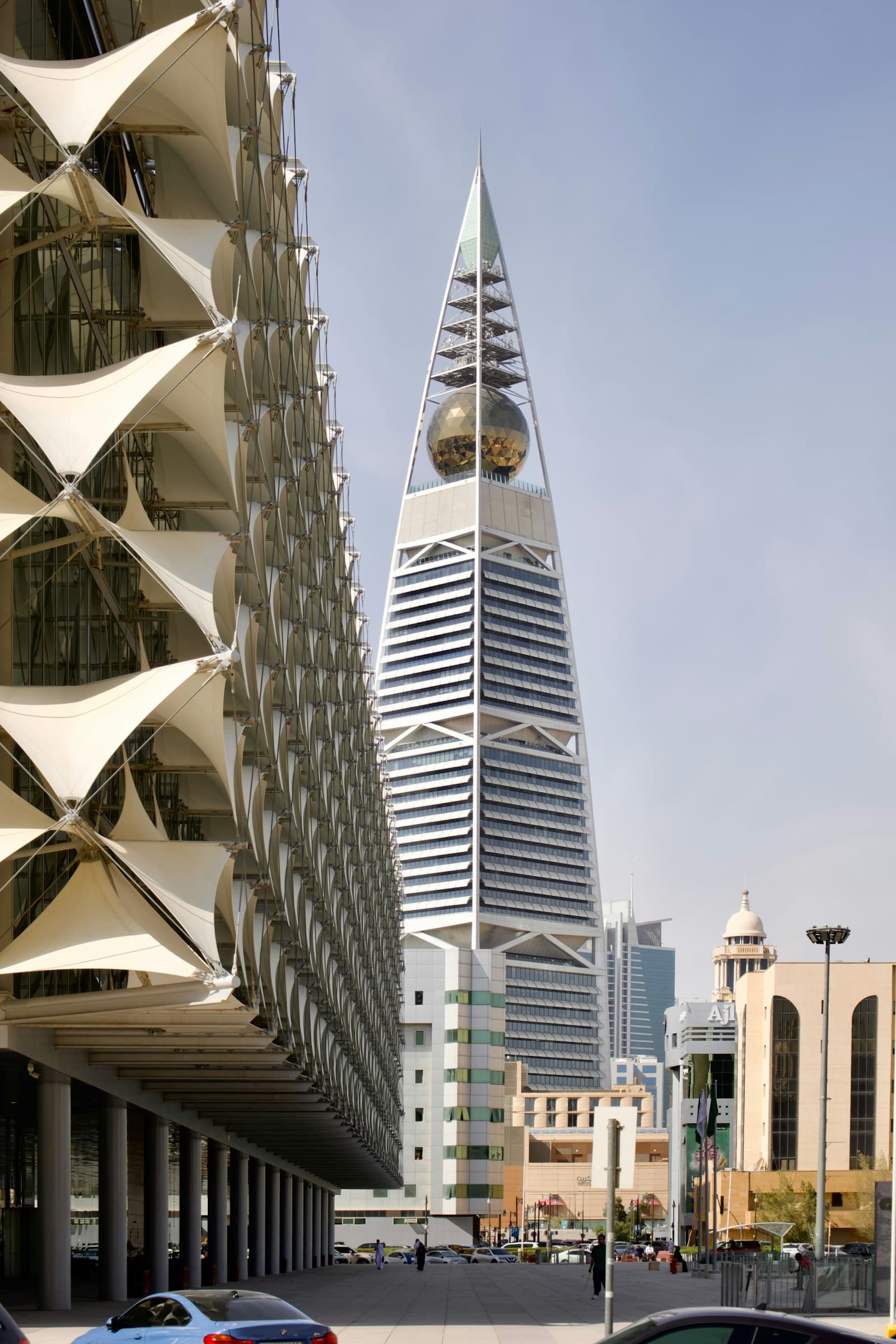 Modern Riyadh architecture with a geometric tower and civic plaza.