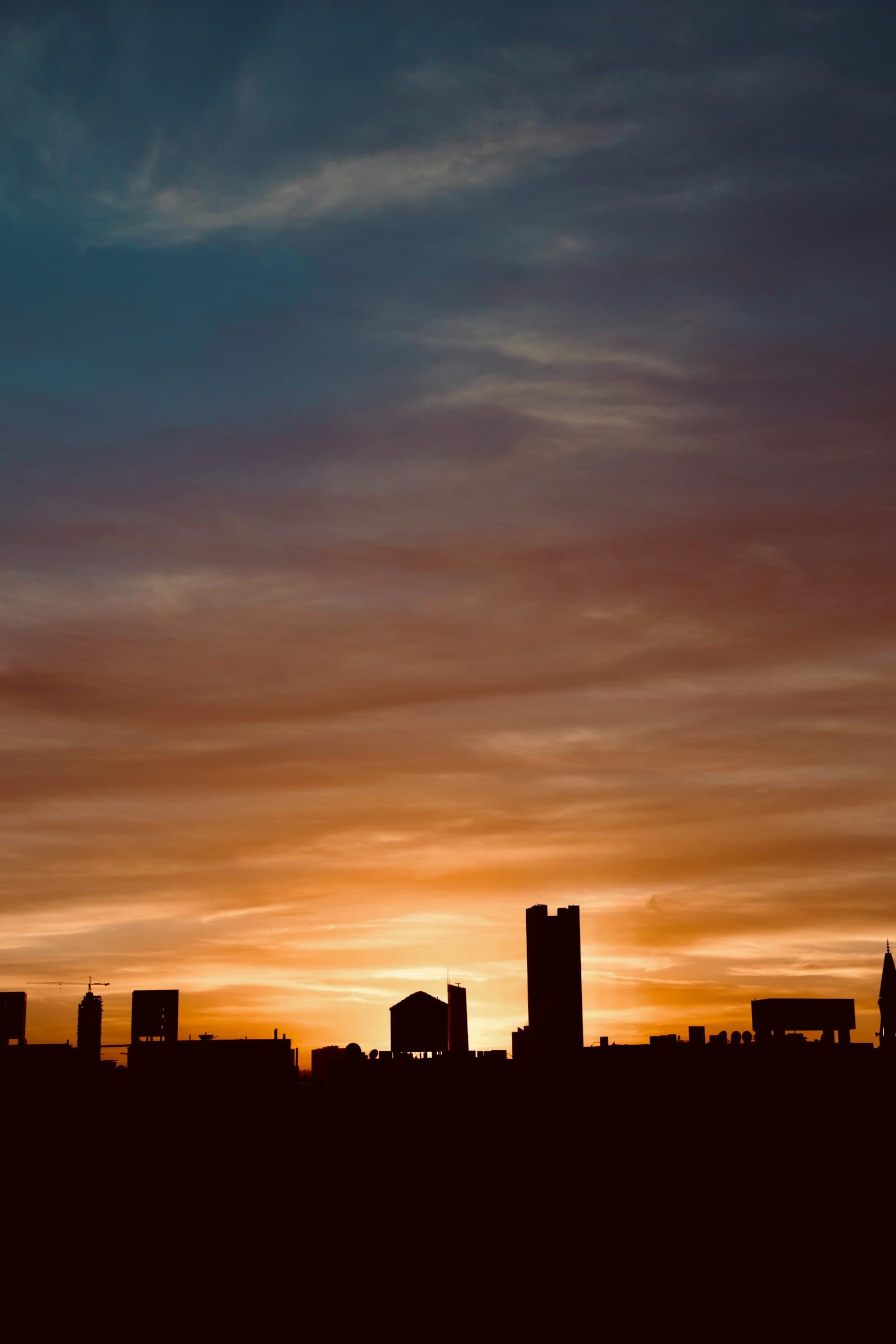 Riyadh skyline at dusk with towers and warm desert light.